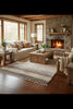 Cozy living room with stone fireplace, wooden coffee table, and comfortable seating.